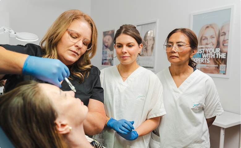 Trainer demonstrating injectables to students